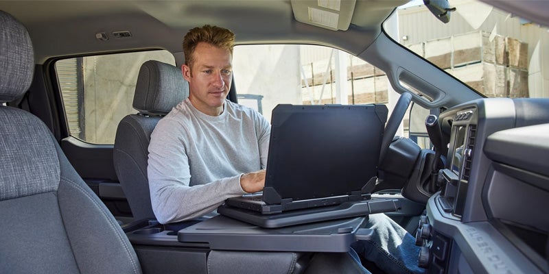 Person using laptop in a vehicle
