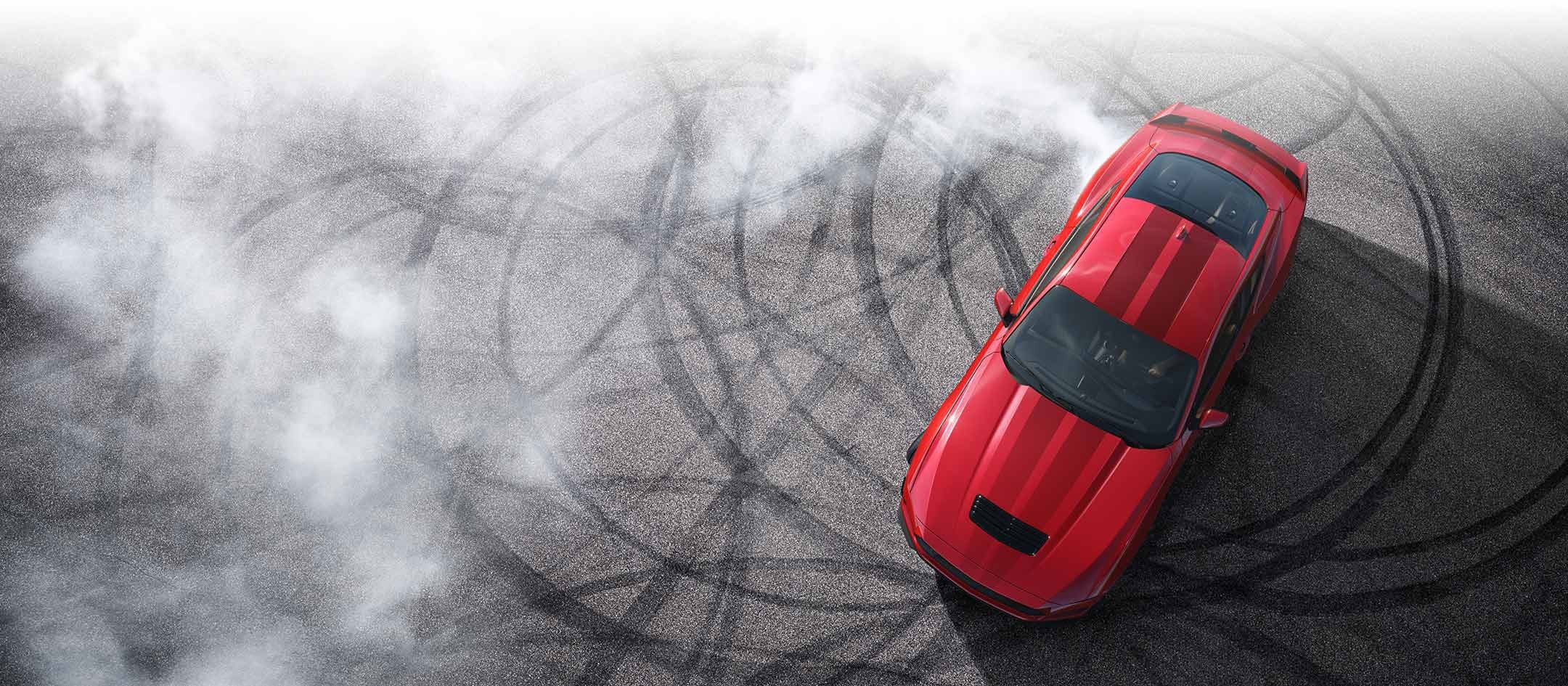 Overhead view of a 2024 Ford Mustang® model with tire tracks on pavement | Winslow Ford in Winslow AZ