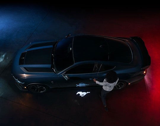 2024 Ford Mustang® Dark Horse™ model with a driver approaching the vehicle | Winslow Ford in Winslow AZ