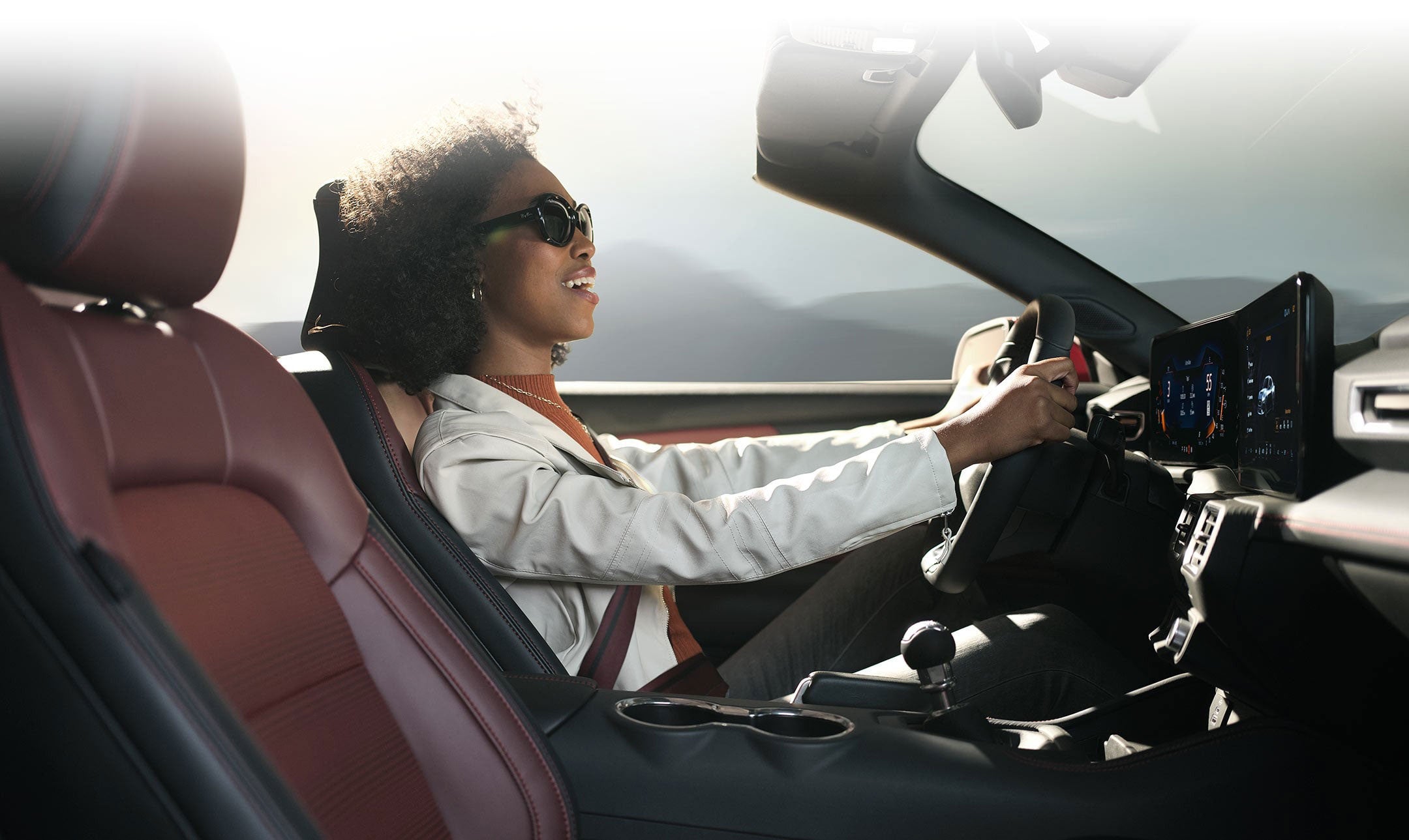 Person sitting in the driver’s seat of a 2024 Ford Mustang® convertible | Winslow Ford in Winslow AZ