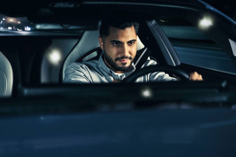 Person sitting in the driver’s seat of a parked 2024 Ford Mustang® coupe | Winslow Ford in Winslow AZ